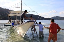 Guests being helped aboard the traditional sea transport